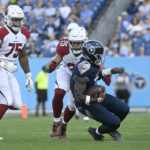 
              Tennessee Titans quarterback Malik Willis (7) is stopped by Arizona Cardinals linebacker Zaven Collins (25) in the first half of a preseason NFL football game Saturday, Aug. 27, 2022, in Nashville, Tenn. (AP Photo/John Amis)
            