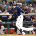 
              Minnesota Twins' Gio Urshela watches his walkoff two-run home run during the bottom of the tenth inning of a baseball game against the Detroit Tigers in Minneapolis, Monday, Aug. 1, 2022. (AP Photo/Abbie Parr)
            