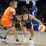 
              Dallas Wings guard Veronica Burton (12) drives against Connecticut Sun guard Natisha Hiedeman (2) in the first quarter during Game 3 of a WNBA first-round playoff series basketball game in Arlington, Texas, Wednesday, Aug. 24, 2022. (AP Photo/LM Otero)
            