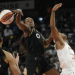 
              Las Vegas Aces guard Jackie Young (0) knocks the ball away from Phoenix Mercury's Kaela Davis, right, during the second half in Game 2 of a WNBA basketball first-round playoff series Saturday, Aug. 20, 2022, in Las Vegas. (AP Photo/John Locher)
            