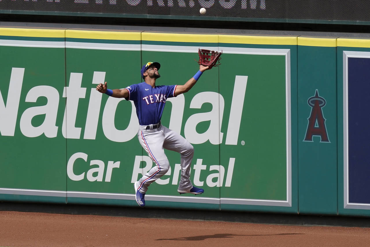 Texas Rangers center fielder Leody Taveras makes a catch on a ball hit by Los Angeles Angels' Luis ...
