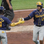 
              Milwaukee Brewers' Willy Adames (27) is greeted by Andrew McCutchen after he scored on a hit by Rowdy Tellez against the Pittsburgh Pirates during the second inning of a baseball game Wednesday, Aug. 3, 2022, in Pittsburgh. (AP Photo/Keith Srakocic)
            