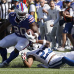 
              Buffalo Bills running back Zack Moss (20) runs with the ball as Indianapolis Colts cornerback Kenny Moore II (23) tries to get a grip on him during the first half of a preseason NFL football game, Saturday, Aug. 13, 2022, in Orchard Park, N.Y. (AP Photo/Jeffrey T. Barnes)
            