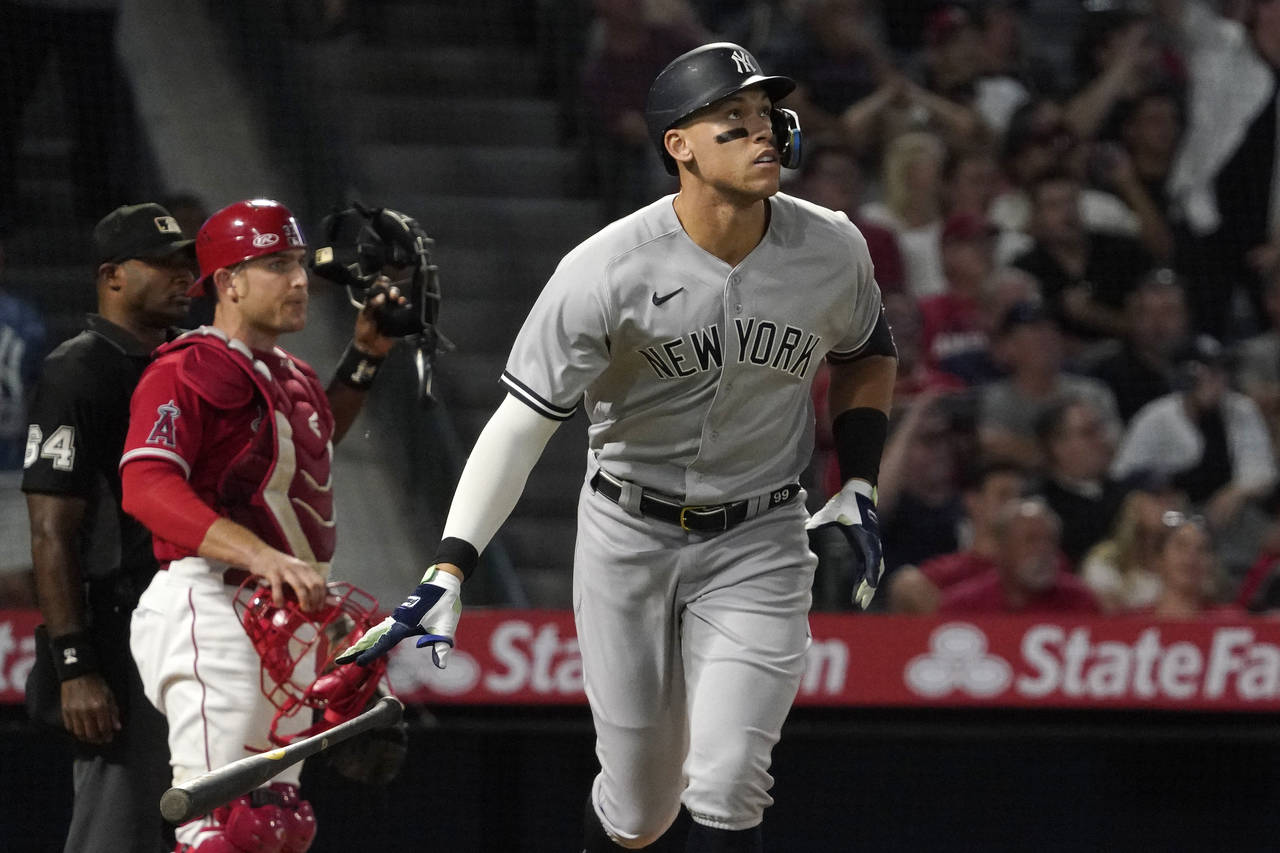 New York Yankees' Aaron Judge, right, drops his bat after hitting a three-run home run, next to Los...