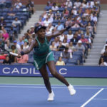 
              Venus Williams, of the United States, returns a shot to Alison Van Uytvanck, of Belgium, during the first round of the US Open tennis championships, Tuesday, Aug. 30, 2022, in New York. (AP Photo/Seth Wenig)
            