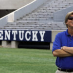 
              FILE - Kentucky coach Hal Mumme smiles as he waits for a photo shoot during the team's media day on Aug. 12, 1999, at Commonwealth Stadium in Lexington, Ky. Of the top 25 most-prolific passing seasons in major college football history by yards per game, 12 have direct connections to Mumme and Mike Leach — from Kentucky to Houston to Texas Tech to New Mexico State to Washington State. (AP Photo/Ed Reinke, File)
            