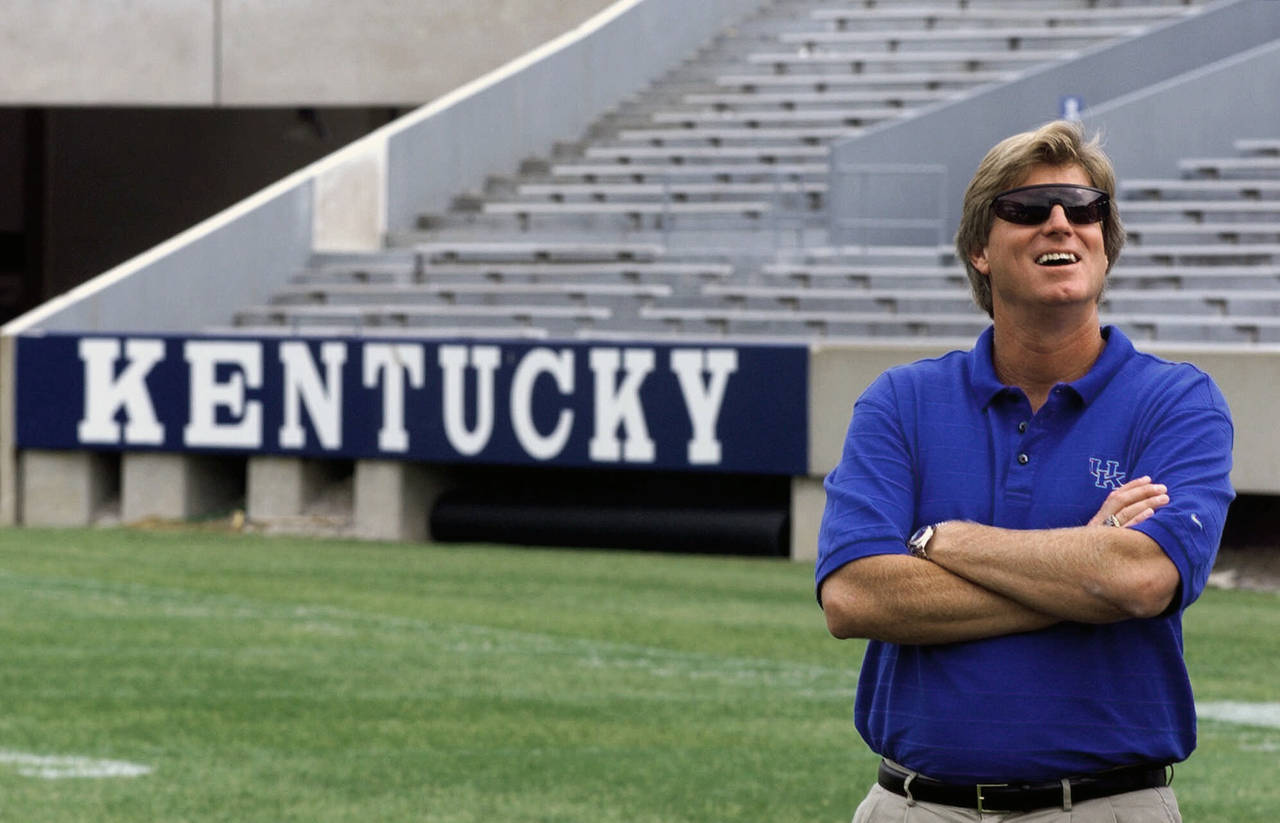 FILE - Kentucky coach Hal Mumme smiles as he waits for a photo shoot during the team's media day on...