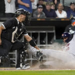 
              Houston Astros' Yuli Gurriel (10) scores next to Chicago White Sox catcher Seby Zavala during the third inning of a baseball game Tuesday, Aug. 16, 2022, in Chicago. (AP Photo/Charles Rex Arbogast)
            