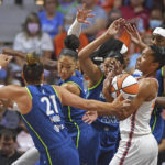 
              Connecticut Sun forward Alyssa Thomas, front right, battles against, from left to right, Minnesota Lynx guard Kayla McBride (21), forward Aerial Powers (3), forward Napheesa Collier (24), and center Sylvia Fowles (34) for a rebound during a WNBA basketball game Sunday, Aug. 14, 2022, in Uncasville, Conn. (Sean D. Elliot/The Day via AP)
            