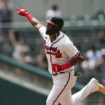 
              Atlanta Braves' Orlando Arcia (11) gestures as he rounds the bases after hitting a home run in the fifth inning of a baseball game against the Philadelphia Phillies Wednesday, Aug. 3, 2022, in Atlanta. (AP Photo/John Bazemore)
            