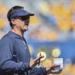 
              FILE - West Virginia head coach Neal Brown reacts during the first half of an NCAA college football game against Virginia Tech in Morgantown, W.Va., Saturday, Sept. 18, 2021. The Backyard Brawl returns after a 10-year hiatus on Thursday night when 17th-ranked Pitt hosts West Virginia. (AP Photo/William Wotring, File)
            