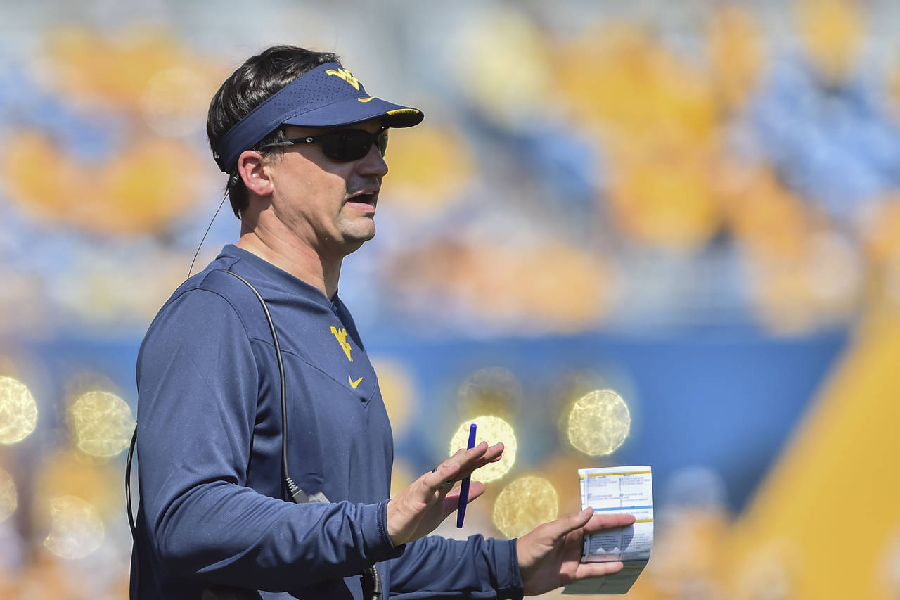 FILE - West Virginia head coach Neal Brown reacts during the first half of an NCAA college football...