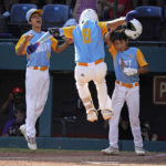 
              Honolulu's Rustan Hiyoto (8) leaps onto home plate after hitting a two-run home run off Nolensville, Tenn.'s Trent McNeil in the fourth inning of the United State Championship baseball game at the Little League World Series tournament in South Williamsport, Pa., Saturday, Aug. 27, 2022. (AP Photo/Gene J. Puskar)
            