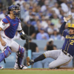 
              Milwaukee Brewers' Willy Adames (27) scores off of a double hit by Hunter Renfroe during the third inning of a baseball game against the Los Angeles Dodgers in Los Angeles, Wednesday, Aug. 24, 2022. Los Angeles Dodgers catcher Austin Barnes is at left. (AP Photo/Ashley Landis)
            