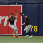 
              Baltimore Orioles left fielder Anthony Santander, left, catches a fly ball in front of center fielder Ryan McKenna (26) during the sixth inning of a baseball game against the Tampa Bay Rays, Saturday, Aug. 13, 2022, in St. Petersburg, Fla. (AP Photo/Scott Audette)
            