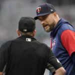 
              Minnesota Twins manager Rocco Baldelli, right, speaks with home plate umpire Jerry Meals, left, after an infield hit by Boston Red Sox's Tommy Pham during the first inning of a baseball game Monday, Aug. 29, 2022, in Minneapolis. (AP Photo/Abbie Parr)
            