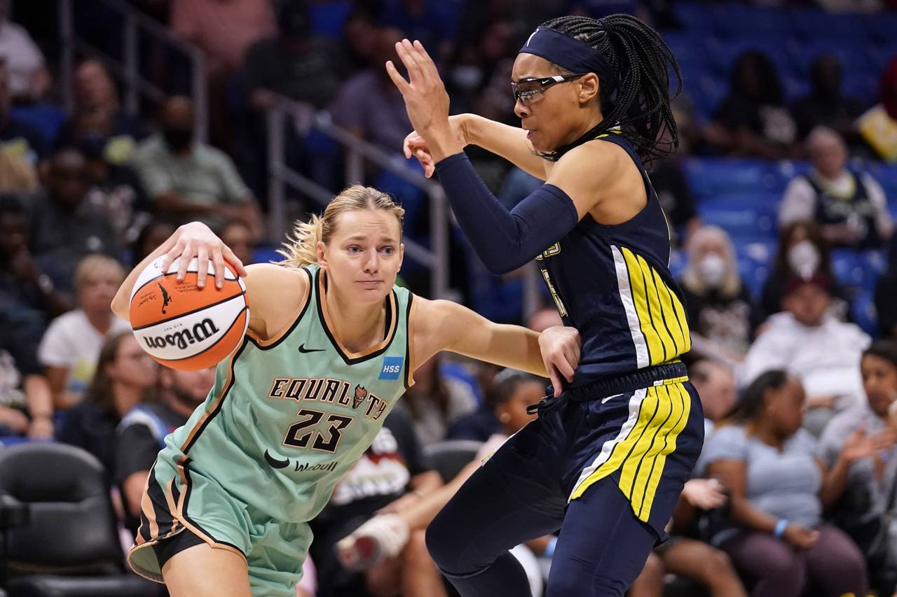 New York Liberty guard Marine Johannes (23) is defended by Dallas Wings guard Allisha Gray during t...