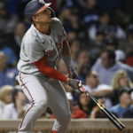 
              Washington Nationals' Joey Meneses watches his two-run home run during the eighth inning of baseball game against the Chicago Cubs, Monday, Aug. 8, 2022, in Chicago. (AP Photo/Paul Beaty)
            