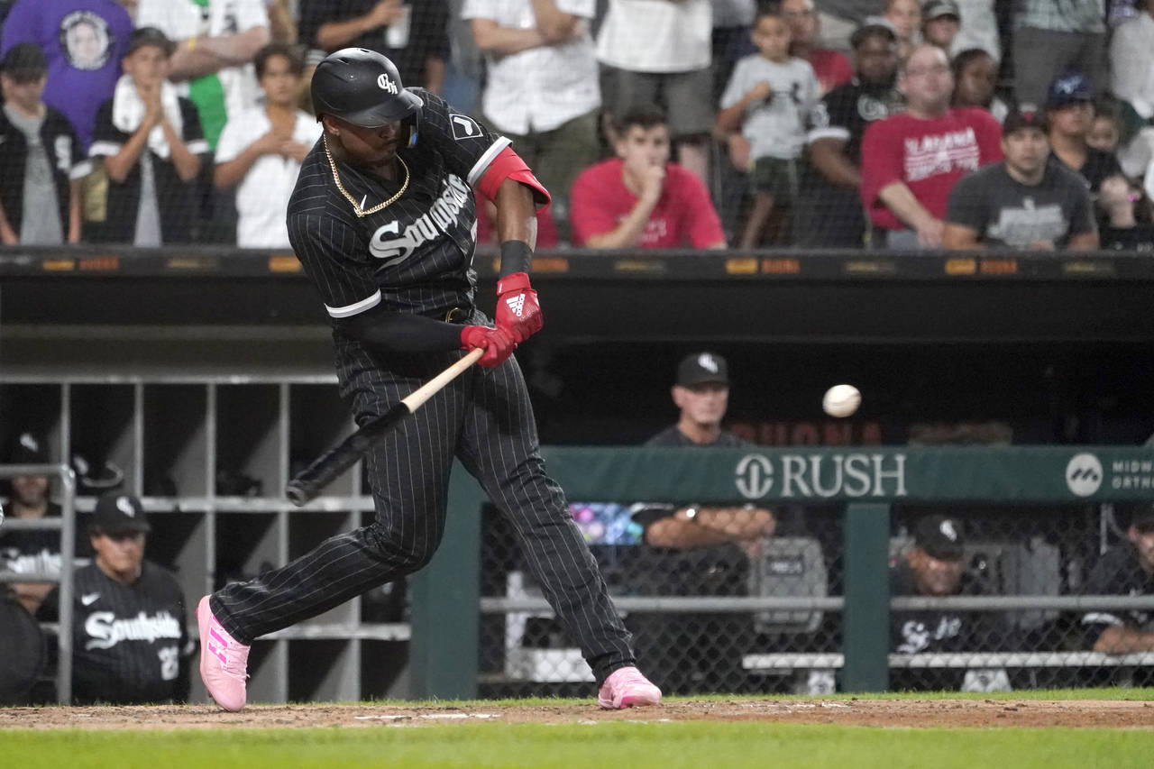 Chicago White Sox's Eloy Jimenez hits a two-run double during the eighth inning of the team's baseb...