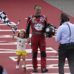 
              Kevin Harvick celebrates with his daughter Piper after winning the NASCAR Cup Series auto race at the Michigan International Speedway in Brooklyn, Mich., Sunday, Aug. 7, 2022. (AP Photo/Paul Sancya)
            