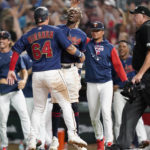 
              Minnesota Twins' Jose Miranda (64) celebrates with teammates after scoring off a walkoff two-run home run by Gio Urshela during the of 10th inning of a baseball game against the Detroit Tigers in Minneapolis, Monday, Aug. 1, 2022. (AP Photo/Abbie Parr)
            