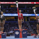 
              Konnor McClain, center, celebrates her first place overall finish with second place winner Shilese Jones, left, and third place winner Jordan Chiles during the U.S. Gymnastics Championships Sunday, Aug. 21, 2022, in Tampa, Fla.(AP Photo/Mike Carlson)
            