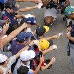 
              Boston Red Sox's Xander Bogaerts, right, gives autographs as his team arrived at the Little League World Series tournament in South Williamsport, Pa., Sunday, Aug. 21, 2022. (AP Photo/Tom E. Puskar)
            