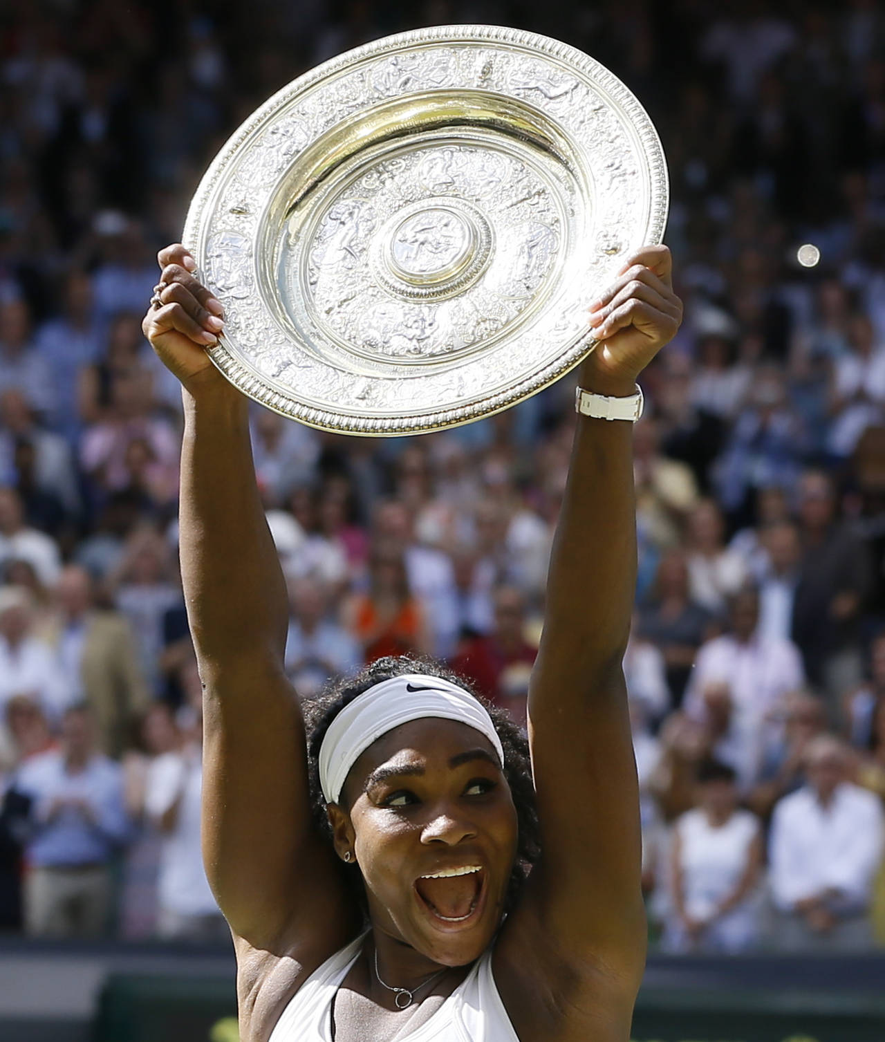 FILE - Serena Williams of the United States reacts as she holds the trophy after winning the women'...