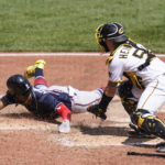 
              Atlanta Braves' Ronald Acuna Jr., left, slides home past Pittsburgh Pirates catcher Tyler Heineman to score from first on a bases-loaded double by Dansby Swanson during the fourth inning of a baseball game, Wednesday, Aug. 24, 2022, in Pittsburgh. (AP Photo/Keith Srakocic)
            