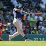 
              Tampa Bay Rays' David Peralta, right, hits an RBI double to right field as Boston Red Sox catcher Reese McGuire, left, looks on in the fifth inning of a baseball game, Sunday, Aug. 28, 2022, in Boston. (AP Photo/Steven Senne)
            