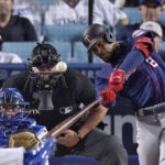 
              Minnesota Twins' Byron Buxton, right, hits a two-run home run as Los Angeles Dodgers catcher Will Smith, left, and home plate umpire Ted Barrett watch during the eighth inning of a baseball game Tuesday, Aug. 9, 2022, in Los Angeles. (AP Photo/Mark J. Terrill)
            