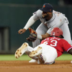 
              Texas Rangers' Adolis Garcia (53) steals second base against Detroit Tigers second baseman Willi Castro, top, during the third inning of a baseball game in Arlington, Texas, Friday, Aug. 26, 2022. (AP Photo/LM Otero)
            