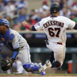 
              Minnesota Twins' Gilberto Celestino scores past Kansas City Royals catcher Salvador Perez during the second inning of a baseball game Tuesday, Aug. 16, 2022, in Minneapolis. (AP Photo/Abbie Parr)
            