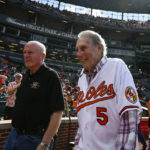 
              Former Baltimore Orioles third baseman Brooks Robinson, right, walks onto the field before a baseball game between the Baltimore Orioles and the Pittsburgh Pirates, Saturday, Aug 6, 2022, in Baltimore. (AP Photo/Terrance Williams)
            