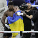 
              Britain's Anthony Joshua, left, embraces Ukraine's Oleksandr Usyk after losing to him in their world heavyweight title fight at King Abdullah Sports City in Jeddah, Saudi Arabia, Sunday, Aug. 21, 2022. (AP Photo/Hassan Ammar)
            