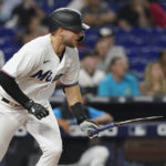 
              Miami Marlins' Charles Leblanc (83) drops his broken bat after a hit in the sixth inning of a baseball game against the Los Angeles Dodgers, Monday, Aug. 29, 2022, in Miami. (AP Photo/Marta Lavandier)
            
