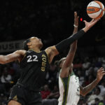 
              Las Vegas Aces forward A'ja Wilson (22) and Seattle Storm guard Jewell Loyd (24) battle for a rebound during the first half in Game 2 of a WNBA basketball semifinal playoff series Wednesday, Aug. 31, 2022, in Las Vegas. (AP Photo/John Locher)
            