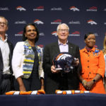 
              Gregory Penner, Condoleezza Rice, Rob Walton, Mellody Hobson and Carrie Walton Penner, from left, of the ownership group that purchased the Denver Broncos, assemble for a group photograph during a news conference at the NFL football team's headquarters Wednesday, Aug. 10, 2022, in Centennial, Colo. (AP Photo/David Zalubowski)
            