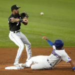 
              Chicago White Sox shortstop Tim Anderson throw to first to complete the double play after forcing Texas Rangers' Marcus Semien at second in the first inning of a baseball game, Thursday, Aug. 4, 2022, in Arlington, Texas. Corey Seager was out at first. (AP Photo/Tony Gutierrez)
            