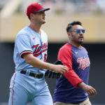 
              Minnesota Twins starting pitcher Tyler Mahle, left, exits the game with head athletic trainer Michael Salazar during the third inning of a baseball game against the Kansas City Royals Wednesday, Aug. 17, 2022, in Minneapolis. (AP Photo/Abbie Parr)
            