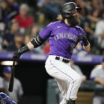 
              Colorado Rockies' Charlie Blackmon follows the flight of his RBI-single off Texas Rangers starting pitcher Dane Dunning in the fifth inning of a baseball game Tuesday, Aug. 23, 2022, in Denver. (AP Photo/David Zalubowski)
            