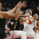 
              Las Vegas Aces center Kiah Stokes (41) battles for the ball with Phoenix Mercury's Kaela Davis, second from right, during the second half in Game 2 of a WNBA basketball first-round playoff series Saturday, Aug. 20, 2022, in Las Vegas. (AP Photo/John Locher)
            