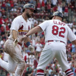 
              St. Louis Cardinals' Paul DeJong, left, is congratulated by first base coach Stubby Clapp (82) after hitting a three-run home run during the eighth inning of a baseball game against the New York Yankees Sunday, Aug. 7, 2022, in St. Louis. (AP Photo/Jeff Roberson)
            