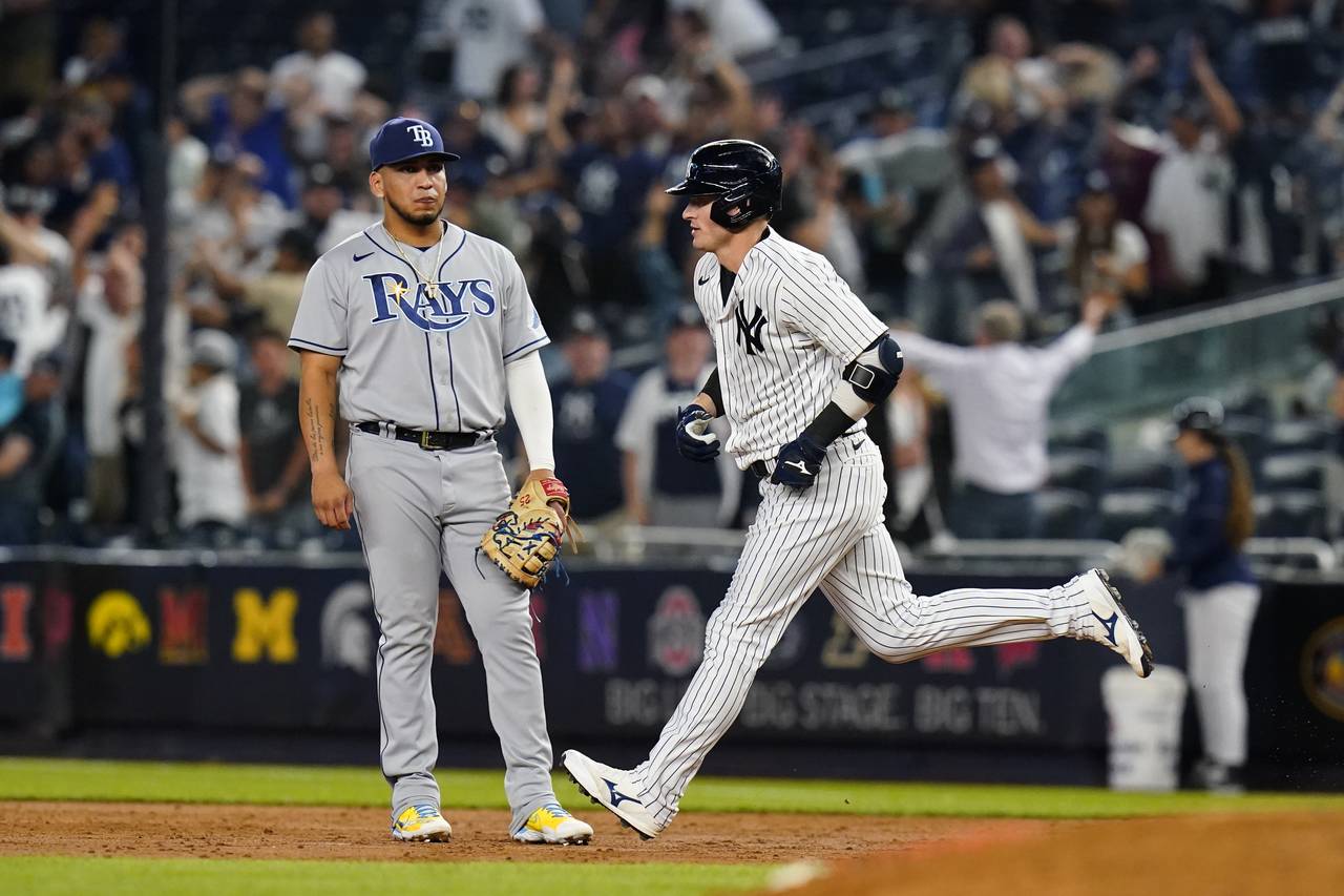New York Yankees' Josh Donaldson passes Tampa Bay Rays' Isaac Paredes as he runs the bases after hi...