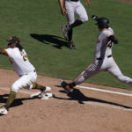 
              San Francisco Giants' Wilmer Flores is late arriving to first as San Diego Padres first baseman Josh Bell makes the catch to complete the double play during the sixth inning of a baseball game Wednesday, Aug. 10, 2022, in San Diego. Joc Pederson was out at second base on the play. (AP Photo/Gregory Bull)
            