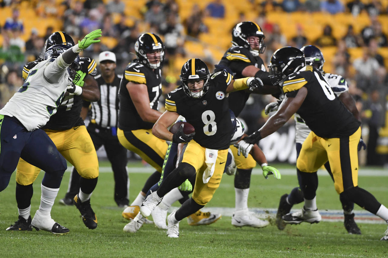 Pittsburgh Steelers quarterback Kenny Pickett (8) scrambles for a first down against the Seattle Se...
