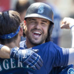 
              Seattle Mariners' Eugenio Suarez, right, hugs Sam Haggerty in the dugout to celebrate Suarez's two-run home run against the Los Angeles Angels during the fifth inning of a baseball game in Anaheim, Calif., Wednesday, Aug. 17, 2022. (AP Photo/Alex Gallardo)
            