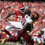 
              Washington Commanders wide receiver Cam Sims (89) catches a touchdown pass as Kansas City Chiefs cornerback Dicaprio Bootle defends during the first half of an NFL preseason football game Saturday, Aug. 20, 2022, in Kansas City, Mo. (AP Photo/Ed Zurga)
            