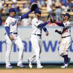 
              From left to right, Los Angeles Dodgers' Trayce Thompson, Cody Bellinger and Mookie Betts celebrate a win over the Miami Marlins in a baseball game Sunday, Aug. 21, 2022, in Los Angeles. (AP Photo/Marcio Jose Sanchez)
            