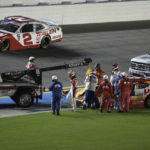 
              Sammy Smith, center, is helped to an ambulance after stopping in the infield grass following a wreck during a NASCAR Xfinity Series auto race at Daytona International Speedway, Friday, Aug. 26, 2022, in Daytona Beach, Fla. (AP Photo/Phelan M. Ebenhack)
            